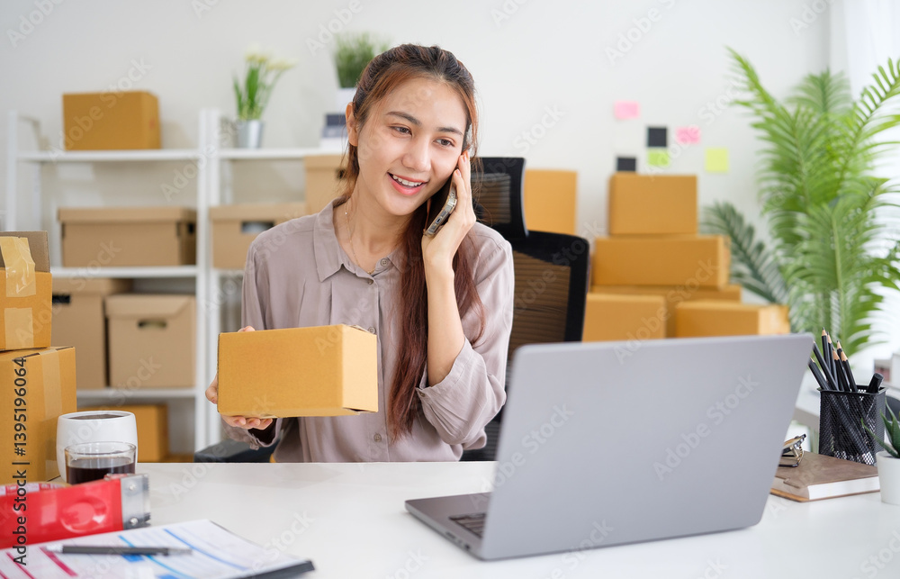 Small business owner talking on mobile phone, preparing a shipment in a workspace filled with cardboard boxes. Small business owner talking on mobile phone, preparing a shipment in a workspace filled with cardboard boxes.