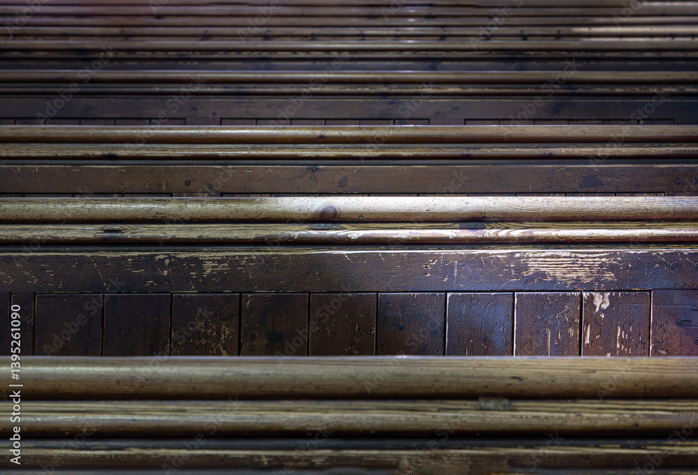 Sunlight filtered through rows of Traditional church benches inside the church. View of The edge of the wooden pews, use it as your Wallpaper, Poster and Space for text, Selective focus.