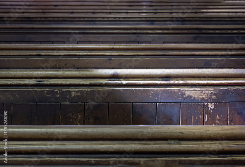 Obraz na płótnie Sunlight filtered through rows of Traditional church benches inside the church. View of The edge of the wooden pews, use it as your Wallpaper, Poster and Space for text, Selective focus. w salonie