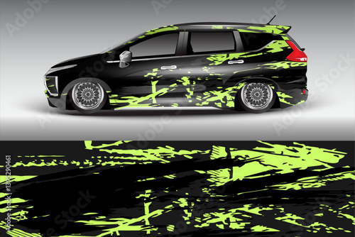 Stylish modified car with vibrant green abstract design parked against a gray backdrop, showcasing urban art