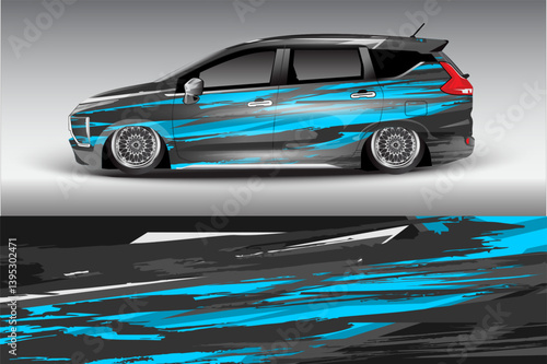Sleek modified car with vibrant blue and black design parked against a gradient gray background