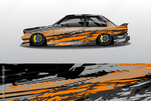 Sleek modified car in side view showcasing vibrant orange and black graphics with a blurred background
