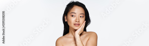 Φωτογραφία Captivating young asian woman expressing beauty and grace with a soft smile