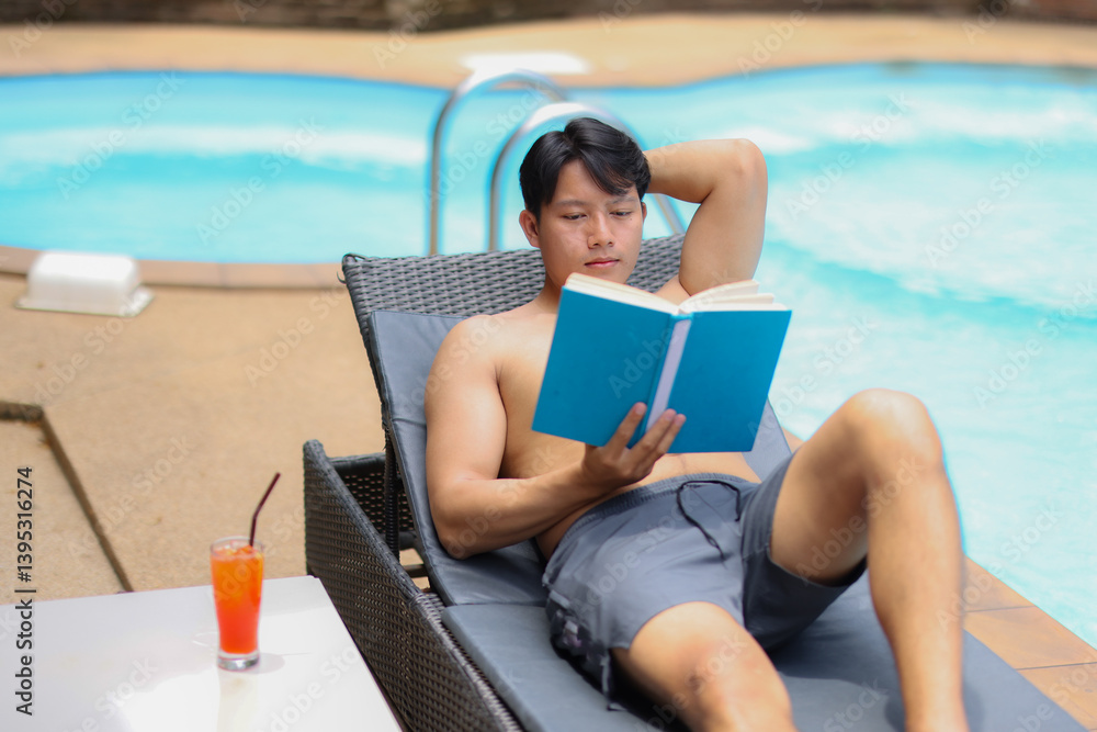 Young man enjoying his vacation, lying on a deck chair by the pool, reading a book and with a refreshing cocktail nearby, during a sunny day Young man enjoying his vacation, lying on a deck chair by the pool, reading a book and with a refreshing cocktail nearby, during a sunny day