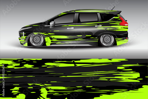 Sleek black car with vibrant green abstract wrap design, showcasing modern automotive aesthetics