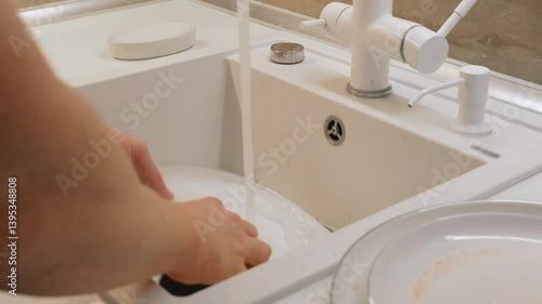 man in the kitchen washing dishes