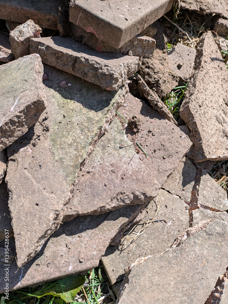 Fototapeta premium Close up of old broken pation pavement slabs dug up from house garden renovation DIY
