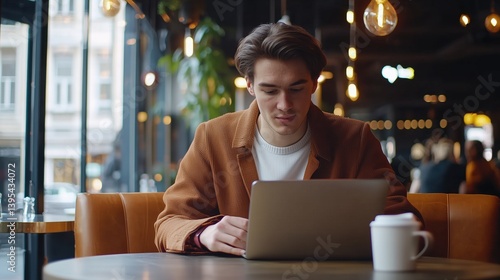 Man Working on Laptop in Cafe