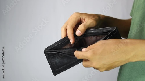 a man shows an empty wallet. a sad person because he has financial problems from a bad job and a small salary.