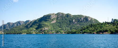 Scenic View on Green Mountains and Fjord Shoreline with Cottages From a Cruise Boat, Stavanger, Norway, June 2018