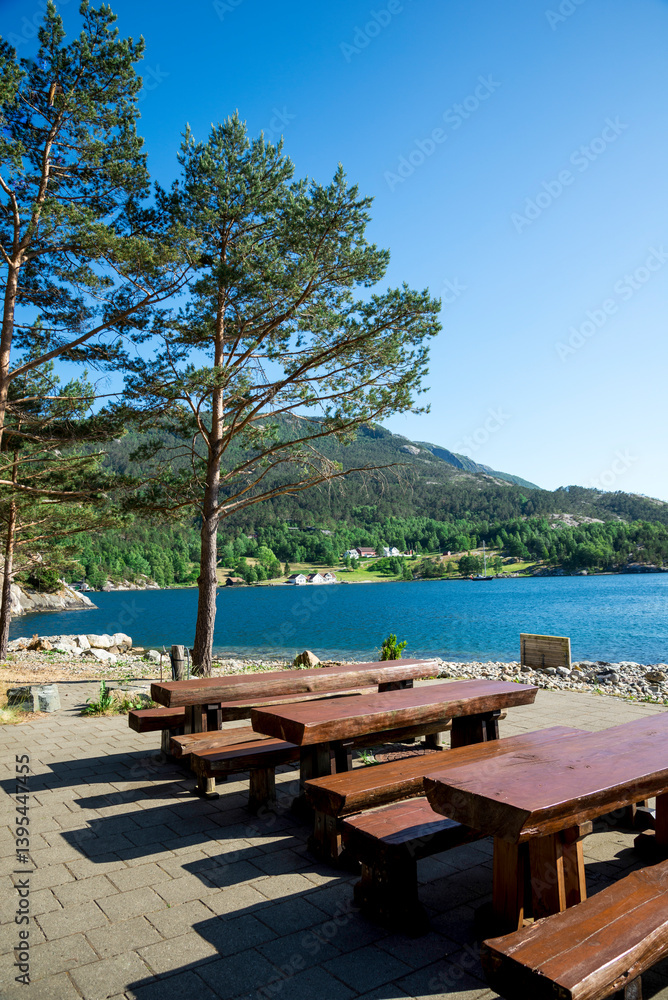 Picnic Area With Natural Wood Tables and Benches And Scenic Mountain View in Lysefjord Fjord, Stavanger, Norway, June 2018