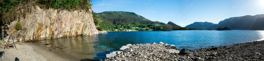 Scenic View of a Beautiful Calm Lysefjord Fjord Surrounded by Mountains from a Small Beach, Stavanger, Norway, June 2018