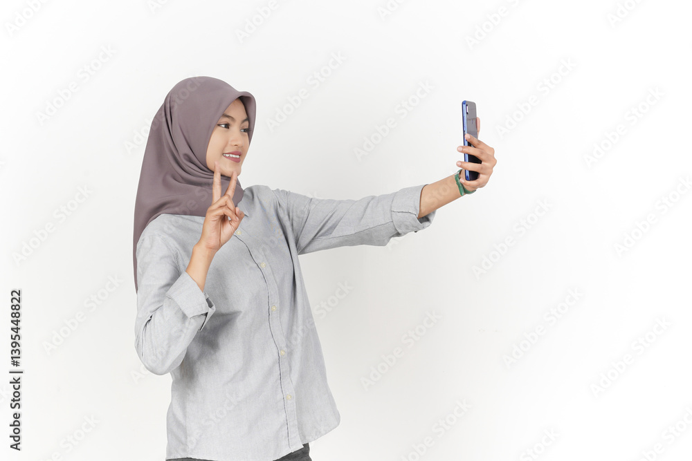 Take a Selfie Using Smartphone Of Beautiful Asian Woman Wearing Hijab Isolated On White Background Take a Selfie Using Smartphone Of Beautiful Asian Woman Wearing Hijab Isolated On White Background