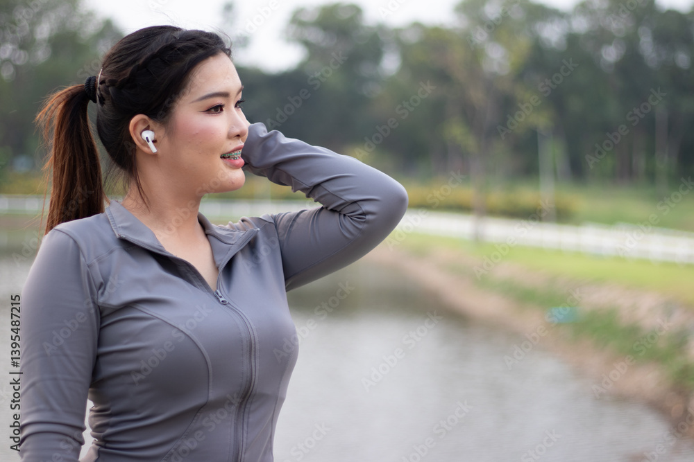 A woman jogger does morning exercise and stretches in an outdoor park. A woman jogger does morning exercise and stretches in an outdoor park.
