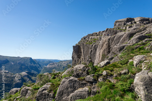 Obraz na płótnie Dramatic Cliffside Landscape with Hikers and Serene Valley View Near Pulpit Rock, Stavanger, Norway, July 2018 w salonie
