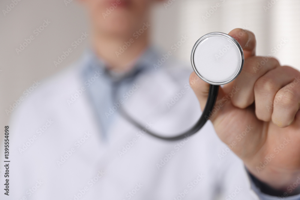 Doctor with stethoscope on light background, closeup Doctor with stethoscope on light background, closeup