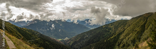 Obraz na płótnie vista panoramica ultra ampia su un ambiente naturale di montagna tra le Alpi nel nord Italia, nella regione Friuli Venezia Giulia, di giorno, in estate, con cielo nuvoloso w salonie