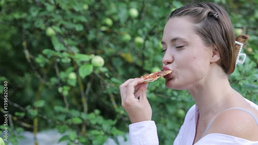 woman in garden eating pizza with drink in summer on picnic woman in garden eating pizza with drink in summer on picnic
