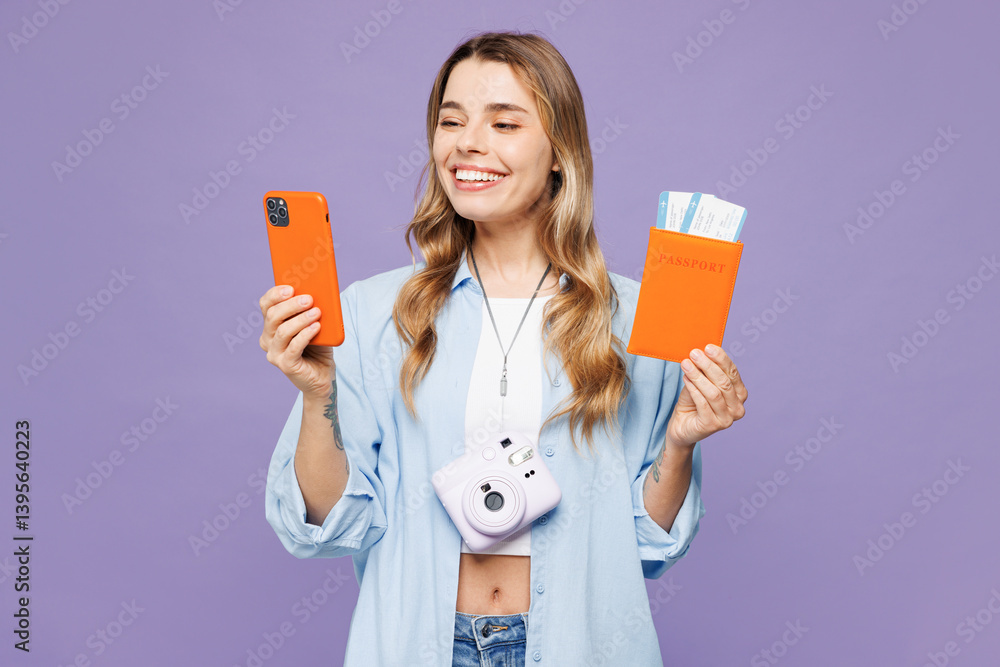 Traveler woman wear blue clothes hold passport ticket use mobile cell phone isolated on plain purple background. Tourist travel abroad in free spare time rest getaway. Air flight trip journey concept. Traveler woman wear blue clothes hold passport ticket use mobile cell phone isolated on plain purple background. Tourist travel abroad in free spare time rest getaway. Air flight trip journey concept.