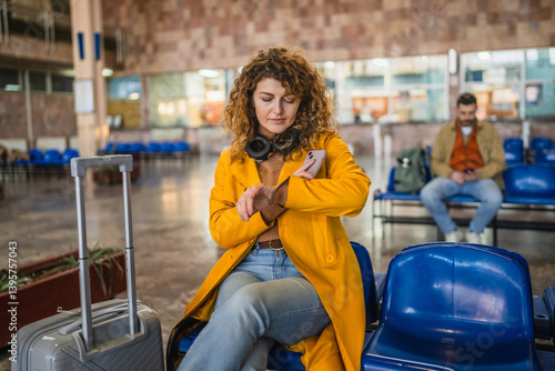 Bild auf Leinwand bored impatient curly hair woman wait for train on the station