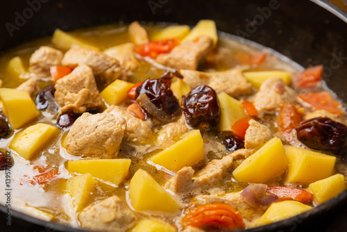 A rich chelnt with potatoes, beans, onions, meat, spices and dates is stewed
