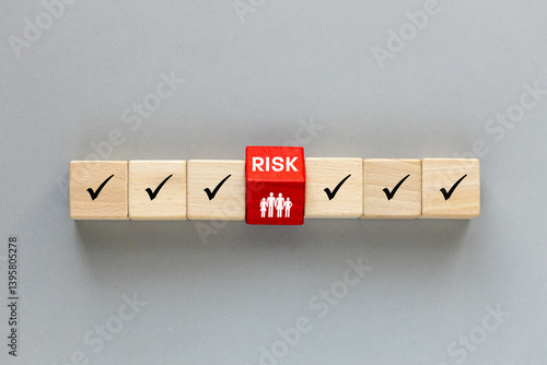 word Risk on wooden blocks. Gray background. Flat lay, Insurance concept. Protection of property and health from risk