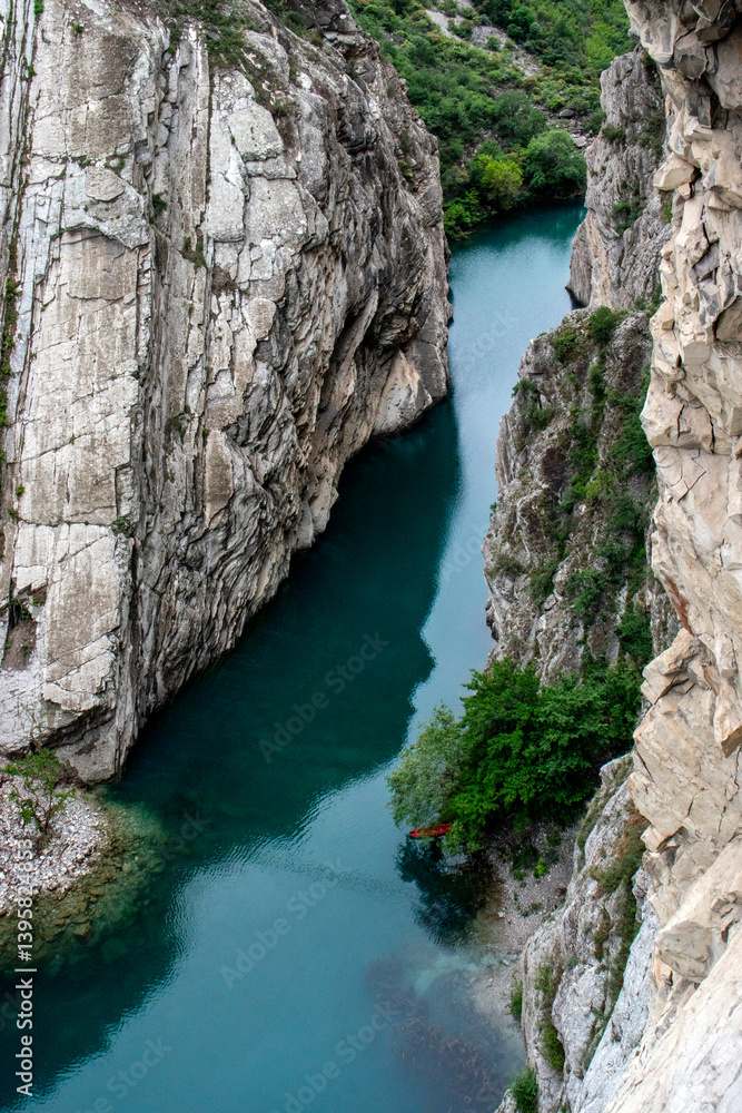 View from above of a turquoise river in a canyon. The Sulak River flows at the bottom of a canyon in Dagestan. Sulak Canyon on a summer day, view from above. View from above of a turquoise river in a canyon. The Sulak River flows at the bottom of a canyon in Dagestan. Sulak Canyon on a summer day, view from above.