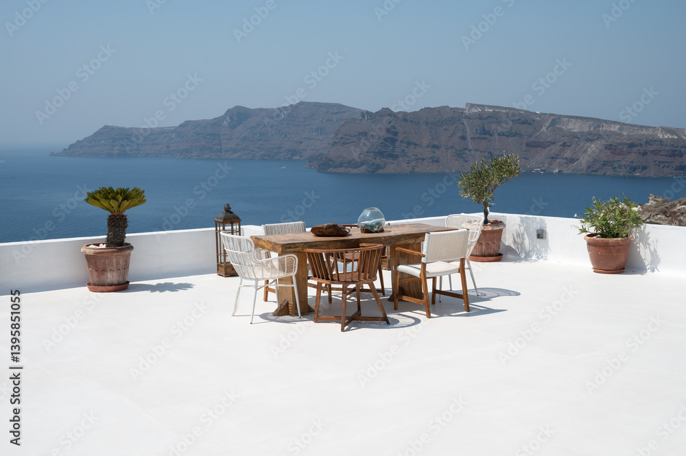 Stylish Wooden Outdoor Furniture on Greek Terrace with Sea View in Oia, Greece
