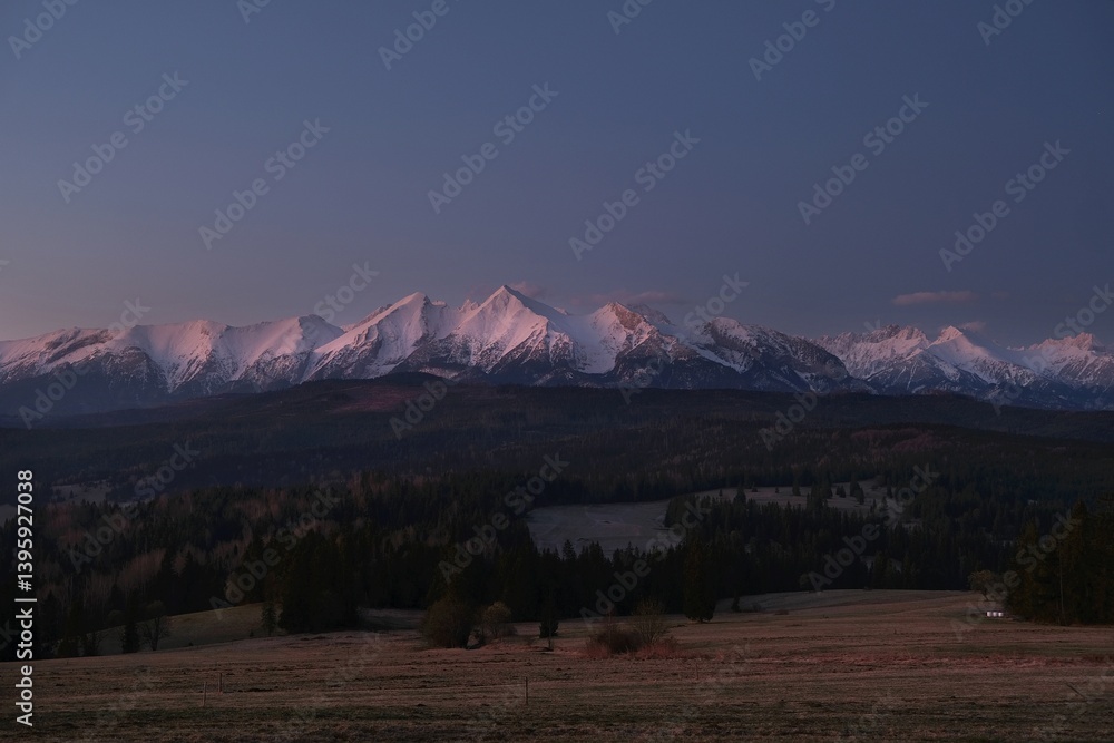The snow-capped peaks of the High Tatras mountains in sunrise light from viewpoint Pass over Lapszanka (Pass over Łapszanka), Podhale, Poland