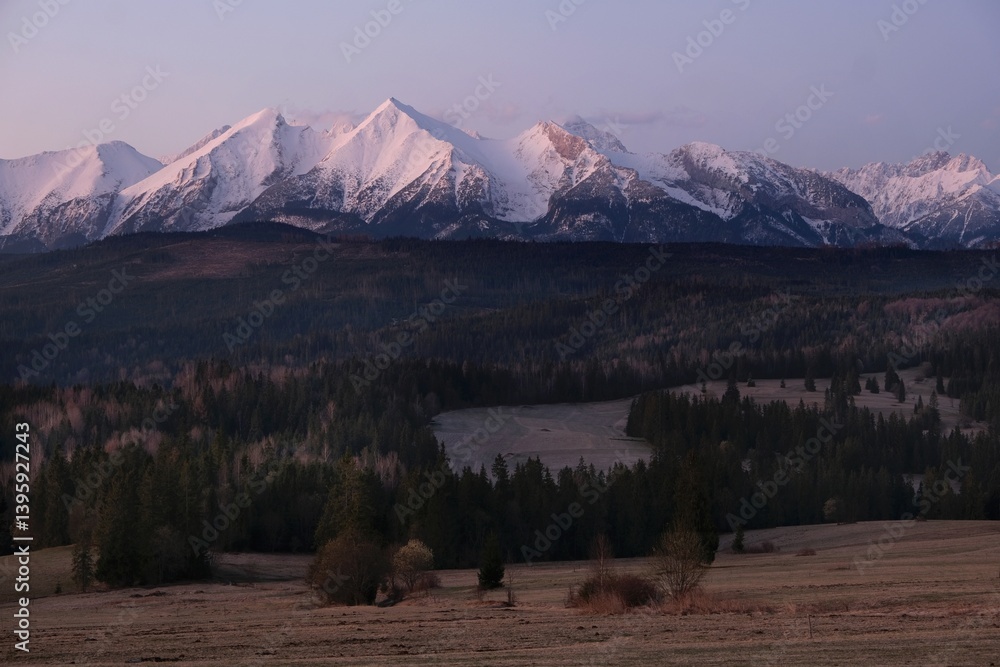 The snow-capped peaks of the High Tatras mountains in sunrise light from viewpoint Pass over Lapszanka (Pass over Łapszanka), Podhale, Poland