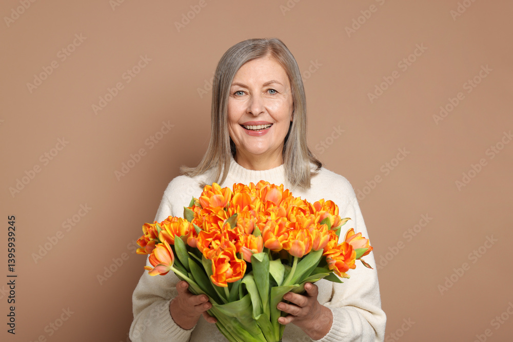 Smiling woman with bouquet of tulips on beige background Smiling woman with bouquet of tulips on beige background