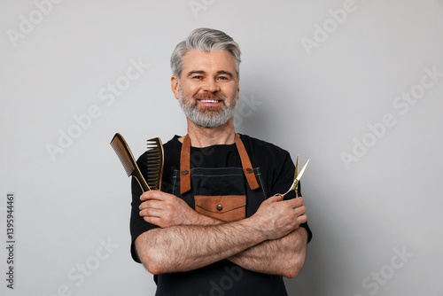 Wallpaper Mural Smiling hairdresser with scissors and combs on gray background Torontodigital.ca