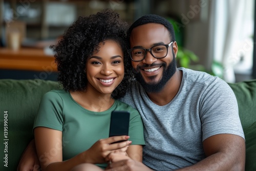 Joyful Couple Enjoying Their Time Together While Watching Something on a Smar...