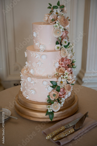 Three-tier blush floral cake with gold base
