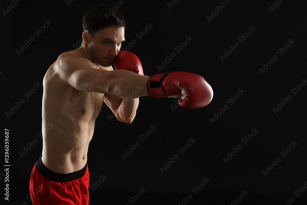 Man in boxing gloves fighting on black background Man in boxing gloves fighting on black background