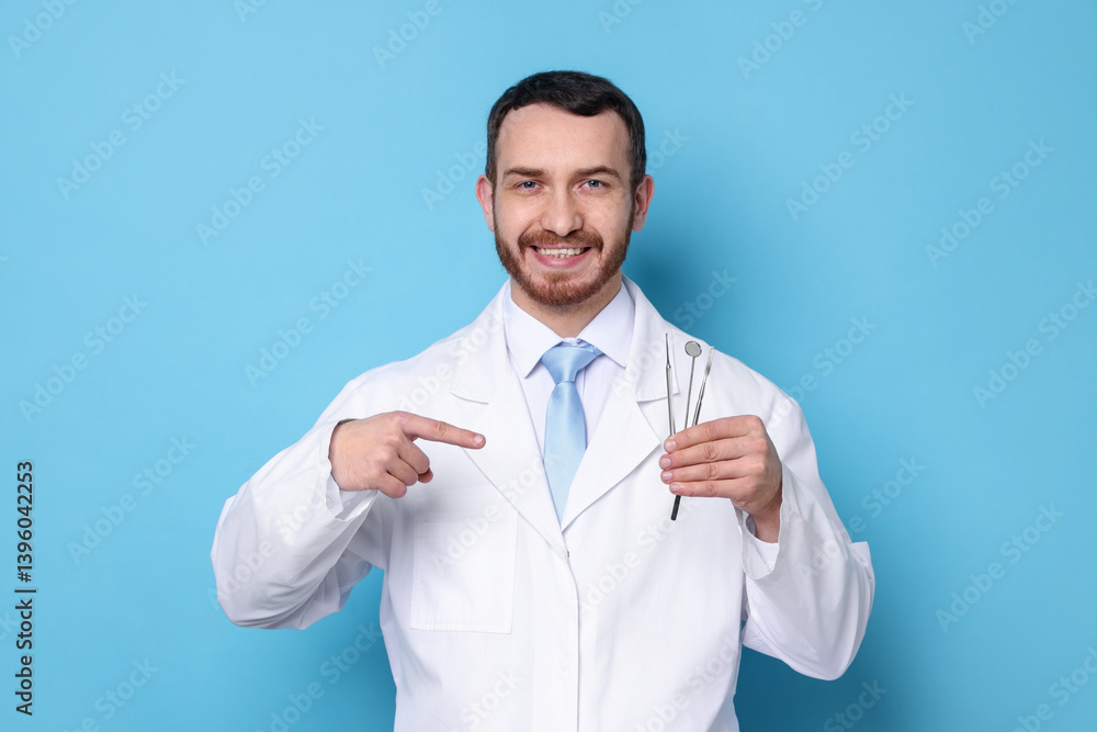 Professional dentist pointing at tools on light blue background Professional dentist pointing at tools on light blue background