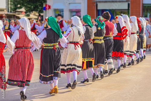 Photography Group of people in folk costumes dancing in traditional circle at cultural event