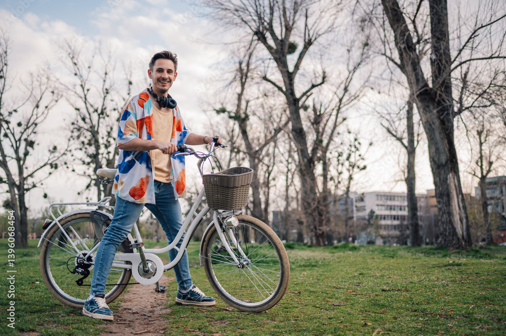 Stylish man posing with bicycle in urban park Stylish man posing with bicycle in urban park