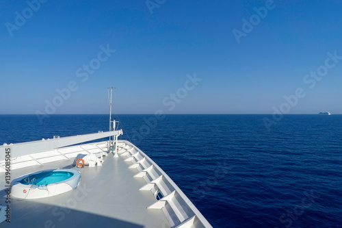 The bow of a cruise liner plows through the ocean.