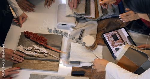 Interior designer reviewing material swatches and color palette on tablet, working on comprehensive design plan with wood, fabric, and tile samples. Concept selection of interior design. Brain Storm