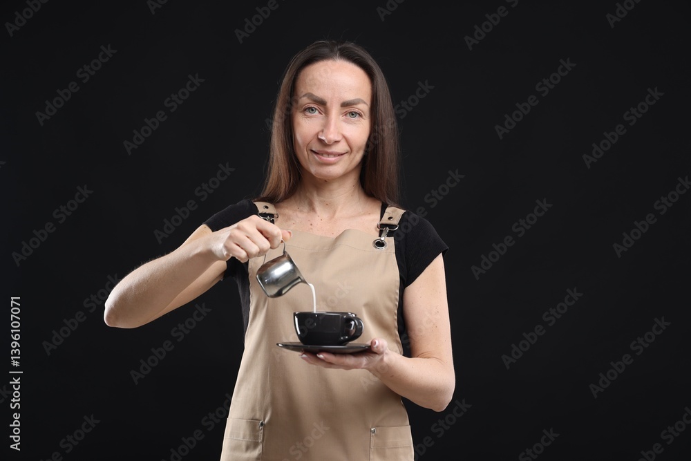 Smiling barista making coffee on black background Smiling barista making coffee on black background