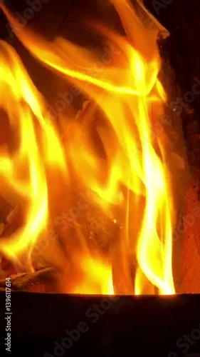 Burning fire. Dynamic close-up footage of a vibrant, burning fire with intense flames flickering and dancing. The fiery blaze emis a warm, glowing light, creating a mesmerizing and hypnotic effect.