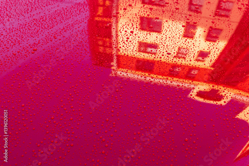 Obraz na płótnie Bright red car hood surface glistening with water droplets w salonie