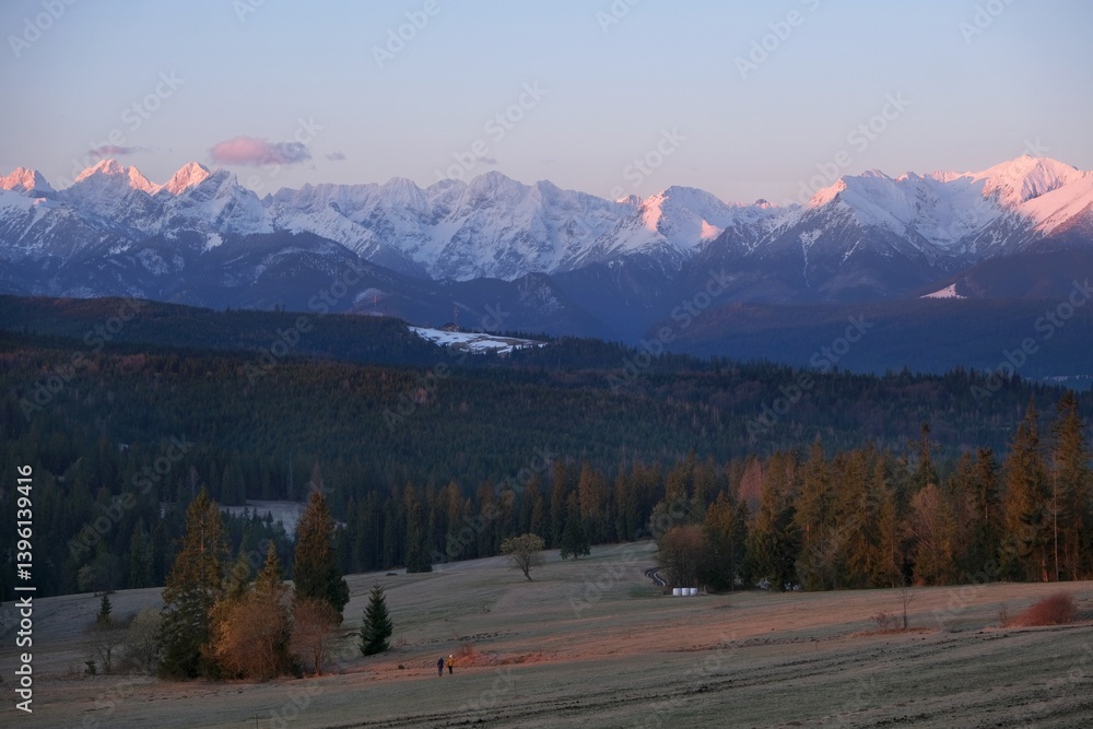 The snow-capped peaks of the High Tatras mountains in sunrise light from viewpoint Pass over Lapszanka (Pass over Łapszanka), Podhale, Poland