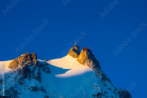 Aiguille du Midi peak in the Alps. Chamonix valley landscape of a prominent rocky towering mountain peak in French Alps. Chamonix-Montblanc area beautiful landscape of Aiguille du Midi summit, France