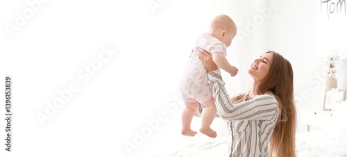 Happy mother playing with c...