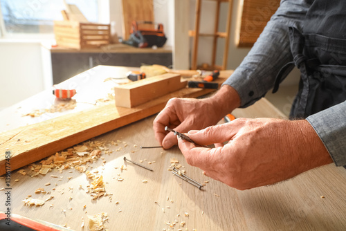 Mature carpenter with nails...