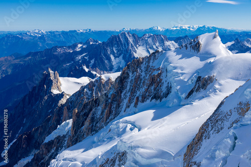 Aiguille du Midi peak in the Alps. Chamonix valley landscape of a prominent rocky towering mountain peak in French Alps. Chamonix-Montblanc area beautiful landscape of Aiguille du Midi summit, France