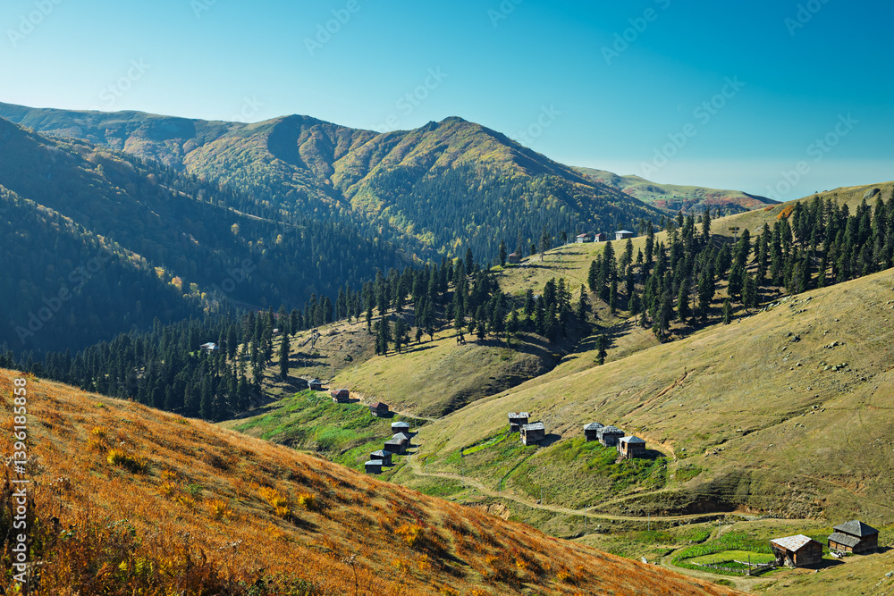 Scenic highland village in Gomis Mta, Georgia, with rustic wooden houses and autumn hues.