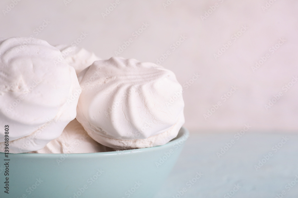Bowl with delicious marshmallows on table against white background. Closeup Bowl with delicious marshmallows on table against white background. Closeup